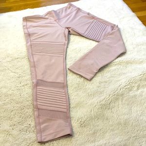 Medium, light pink, high rise legging with moto and mesh detail on legs.